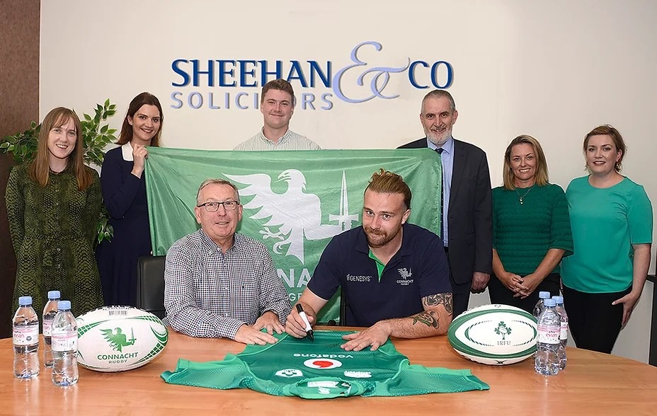 Irish International player Mack Hansen meets the staff in Sheehan and Co. Solicitors, Galway and sign a jersey.